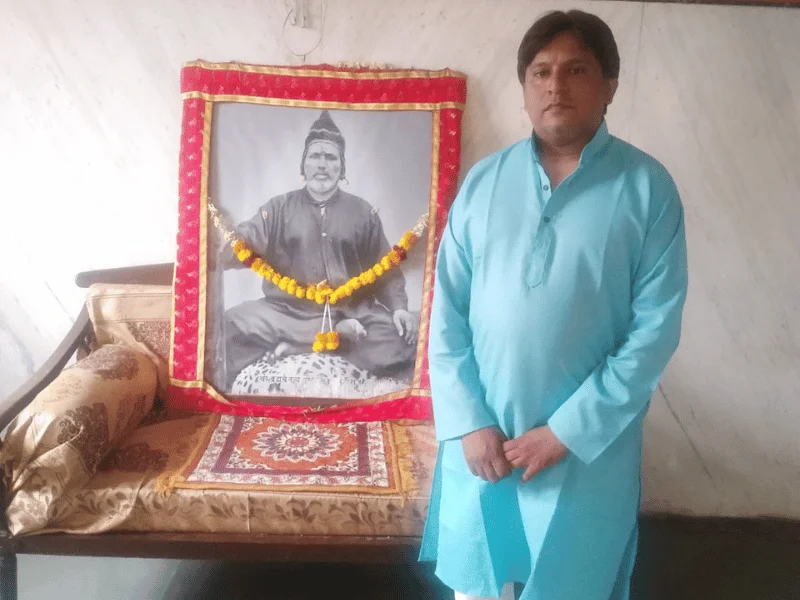 Miitul Kumbhar with spiritual artwork